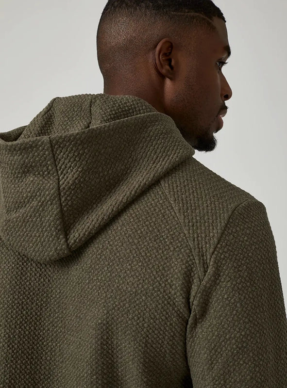 Model Wearing Restoration Hoodie in Olive close up fabric detail view