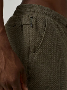 Model Wearing Restoration Joggers in Olive close up fabric detail view