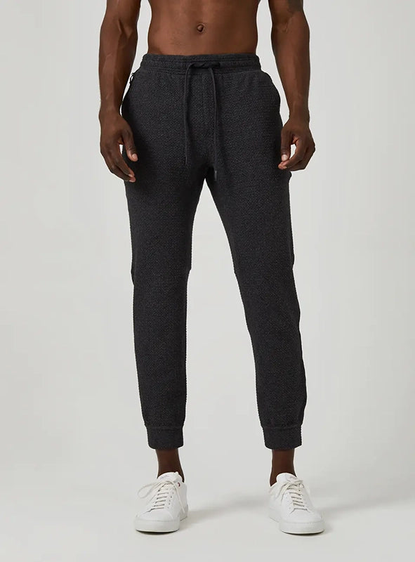 Model Wearing Restoration joggers in charcoal front view