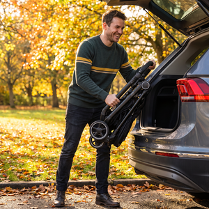 Man wearing charcoal striped pullover sweater with mustard stripe detail outdoors in fall, Sebastian Striped Sweater lifestyle shot - The Simple Man