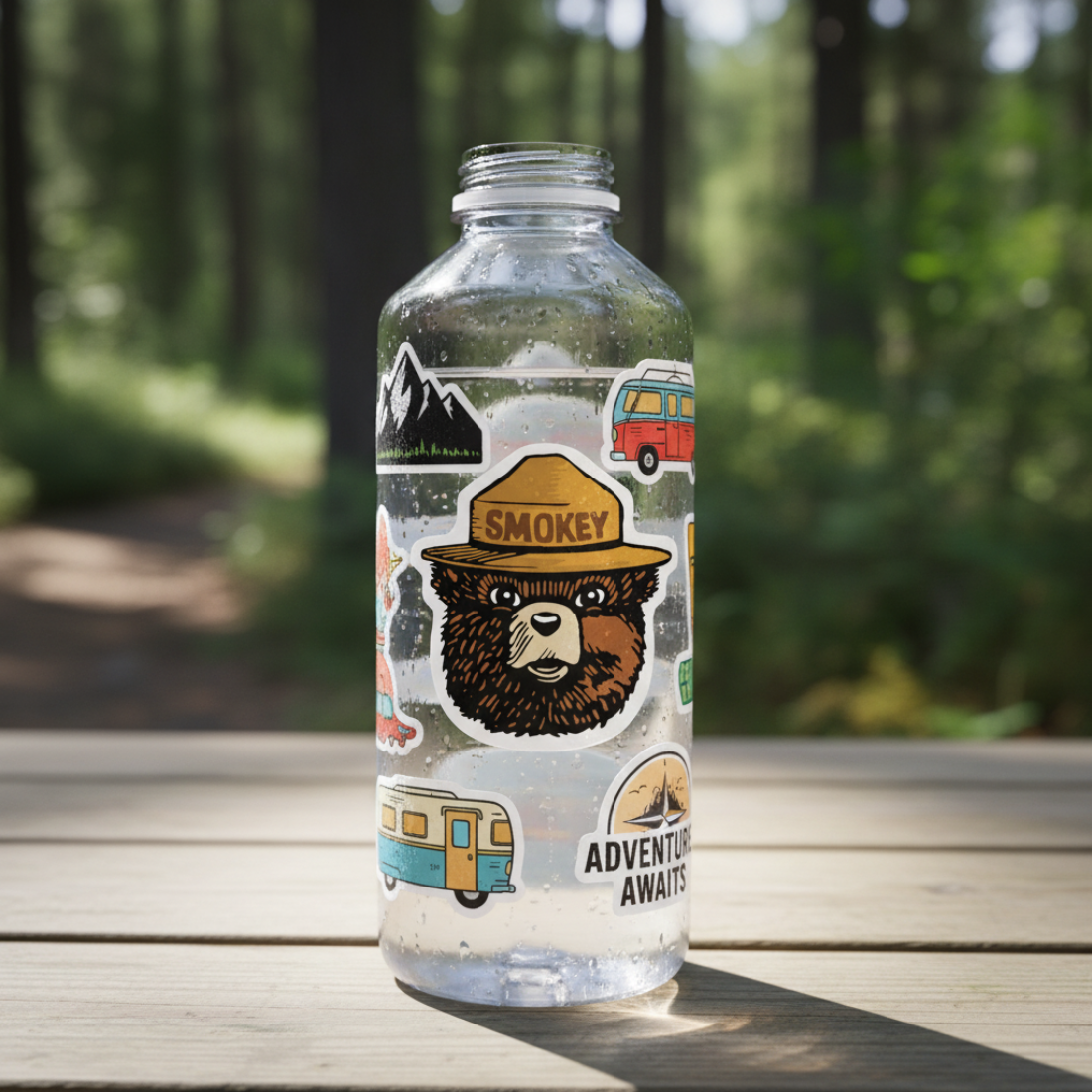 Clear bottle with Smokey Bear sticker  on a wooden surface with a forest background