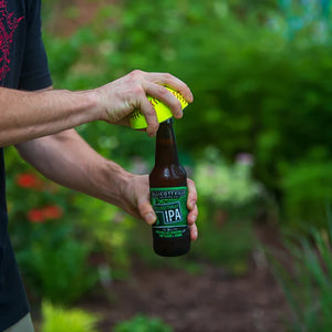 Buffalo Bottlecraft Softball Bottle opener shown opening a bottle