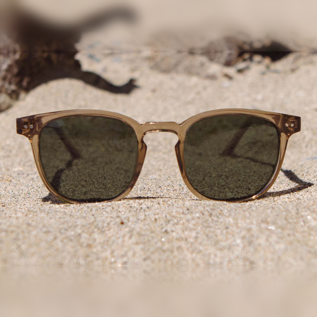 Topo Joshua Tree Edition sunglasses with G15 lenses resting on desert sand