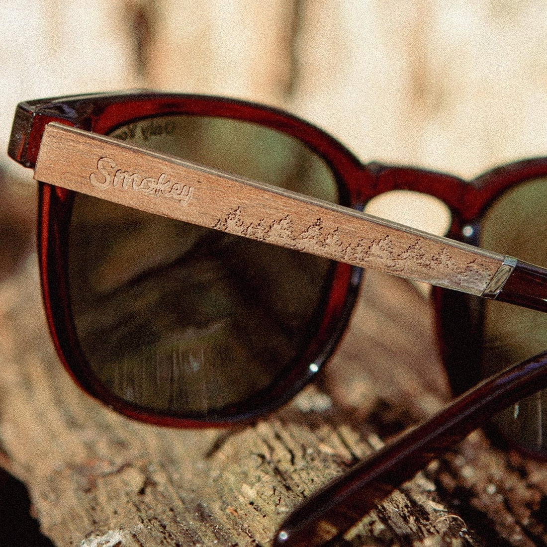 Close-up of the walnut temple engraving on Topo Smokey Bear Edition sunglasses