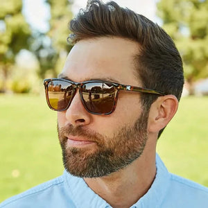 Man wearing Fast Lanes sunglasses in glossy tortoise shell with amber lenses outdoors, The Simple Man