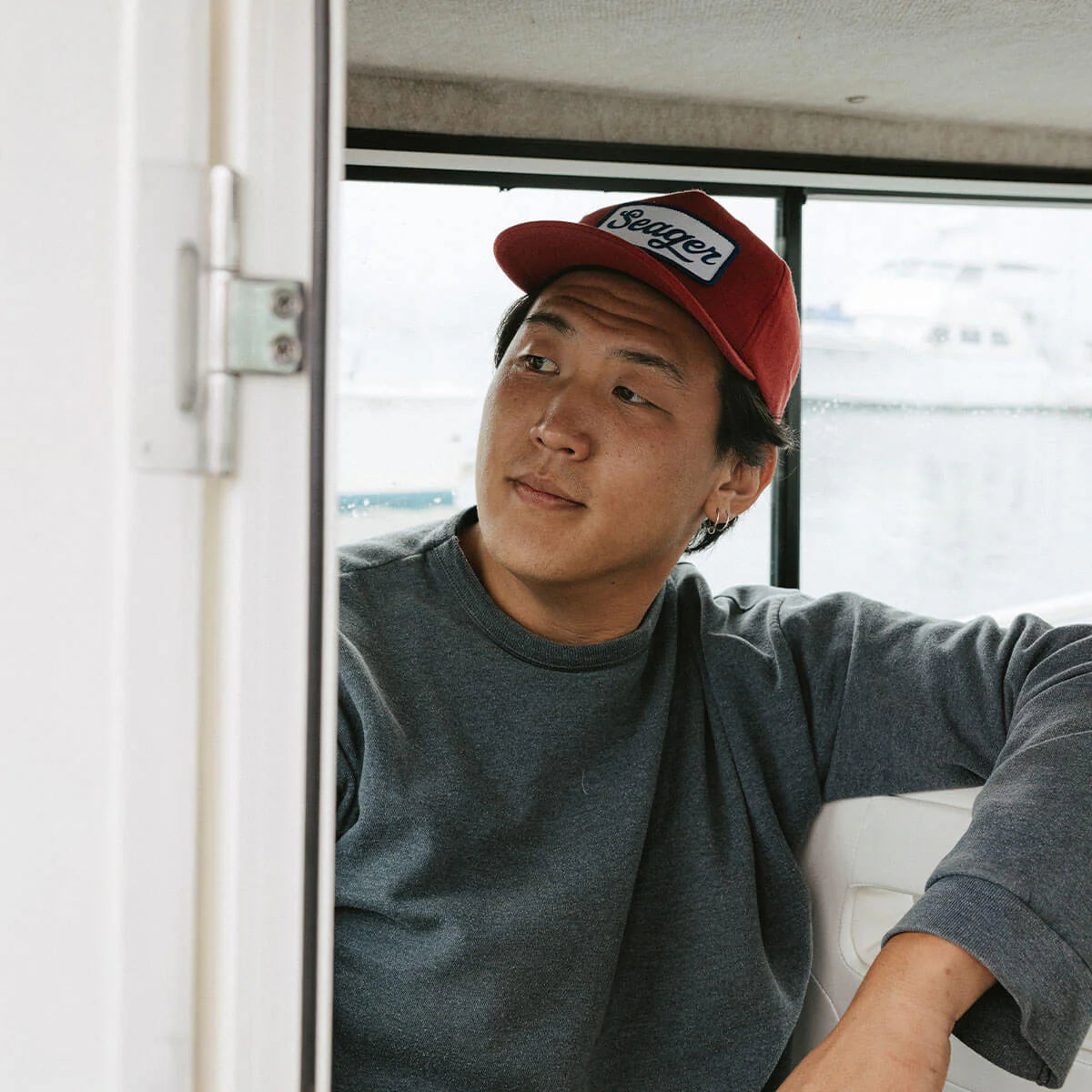 Man wearing Seager Uncle Bill red white blue hemp snapback hat on boat