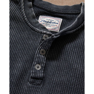 Close-up of the charcoal waffle henley three-button placket and textured knit