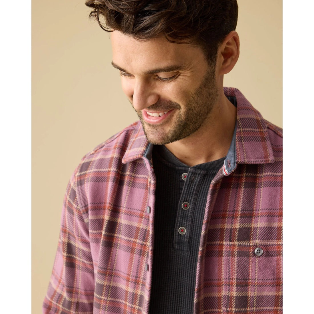 Charcoal waffle henley layered under an open pink plaid flannel shirt
