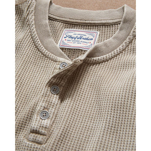 Close-up of the tan waffle henley three-button placket and textured knit