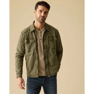 Tan waffle henley layered under an olive jacket with jeans