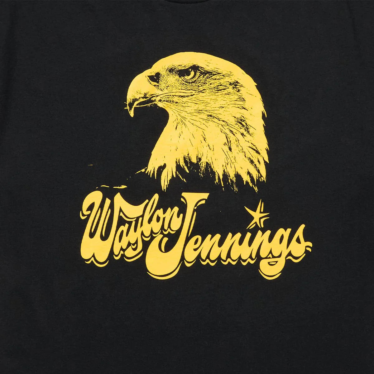 Close-up of Waylon Jennings eagle chest print in yellow on black cotton tee