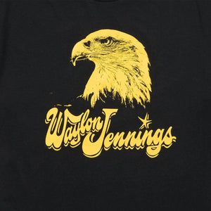 Close-up of Waylon Jennings eagle chest print in yellow on black cotton tee