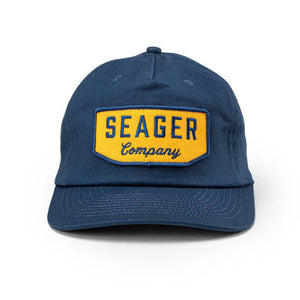 Front-facing view of navy Seager Wilson Snapback Hat with yellow embroidered patch