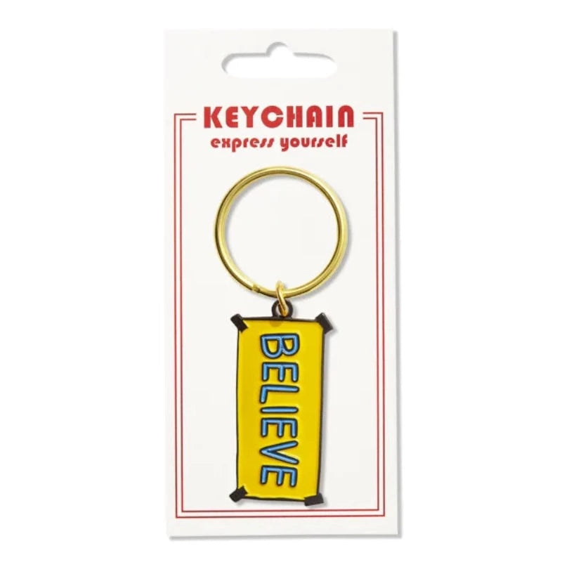 The Found Believe Sign Enamel Keychain In packaging