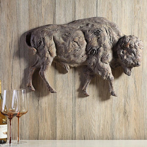 Buffalo Wall Plaque Made of Resin with Antiqued Finish  displayed on a panel wall