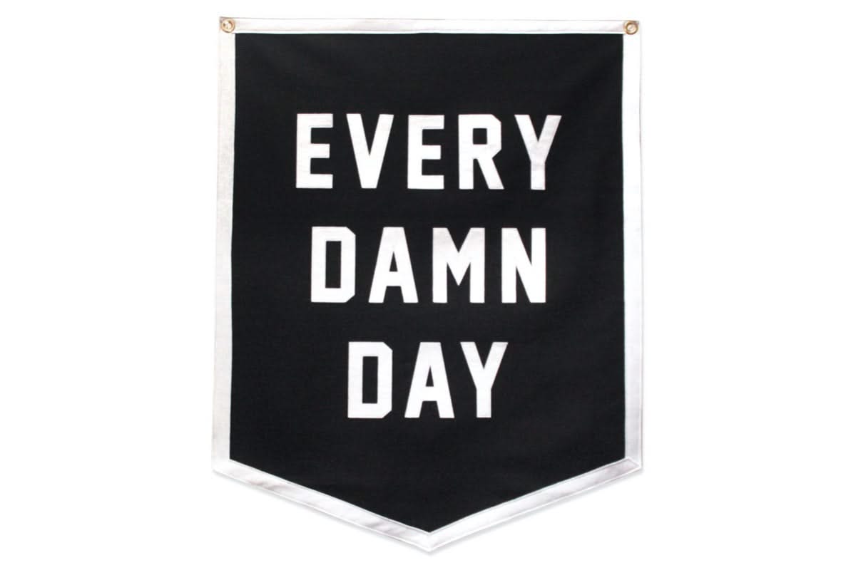 Black and white felt camp banner with “every damn day” screen printed