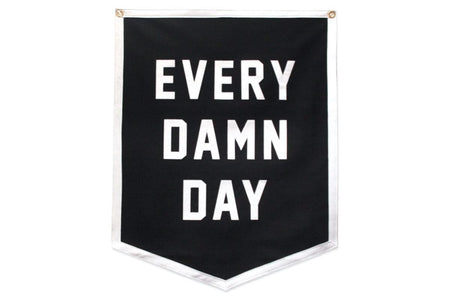 Black and white felt camp banner with “every damn day” screen printed