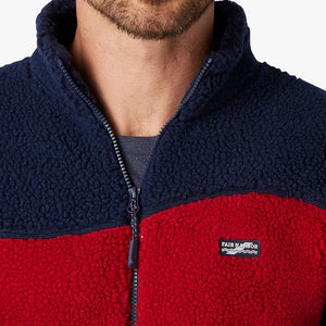 model Wearing Fair Harbor Bayshore Fleece Jacket in red and navy wave Close up View