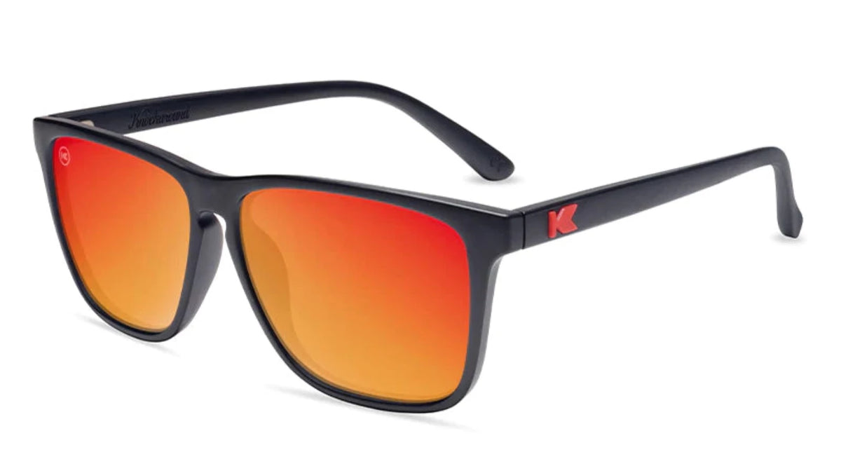 Knockaround Fast lane Sunglasses in Matte Black with Red Sunset lenses Angled front view