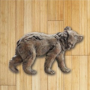 Grizzly bear wall plaque hanging on a wood wall