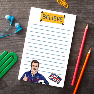 Ted Lasso Believe sign notepad on a table