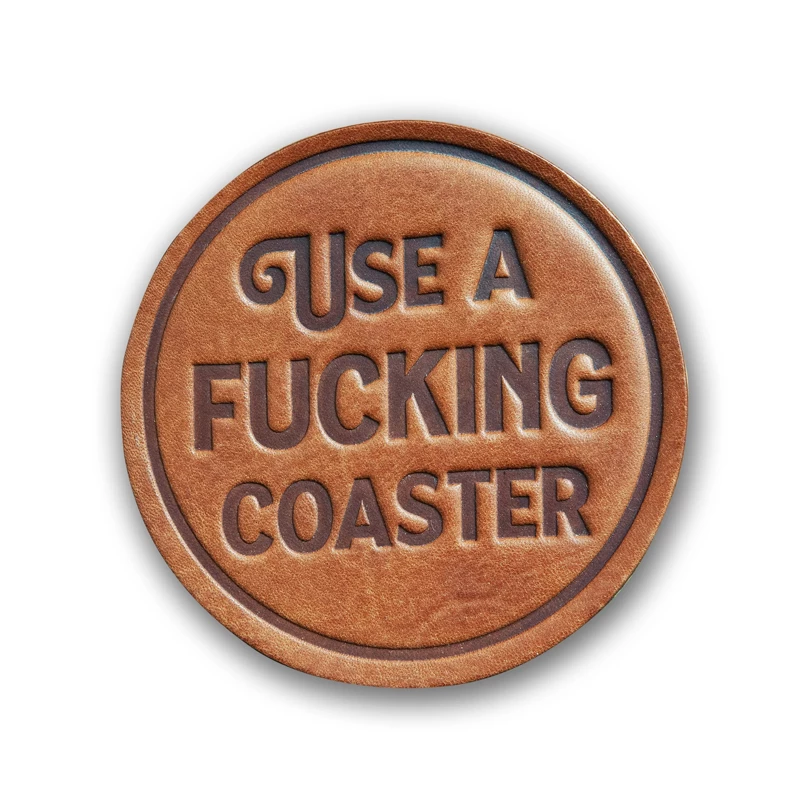 Leather coaster with "Use a Fucking Coaster" stamped on it