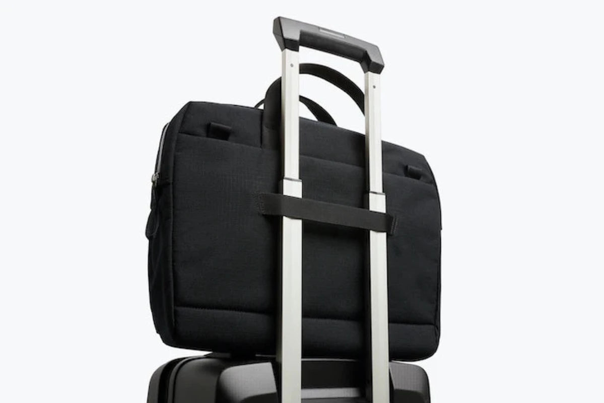 Bellroy Via Work Bag in Black displayed with luggage loop on a suitcase
