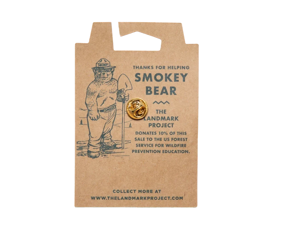 Back of the kraft backing card for the Smokey Bear enamel pin