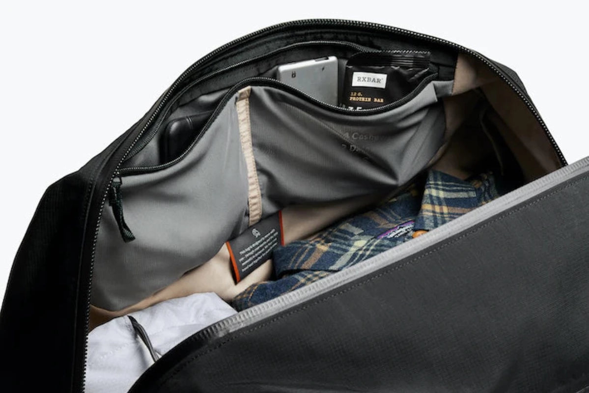 Bellroy Venture Duffel 40L in Midnight open showing side pockets in the bag
